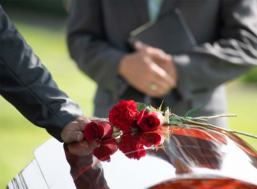 hand on casket roses